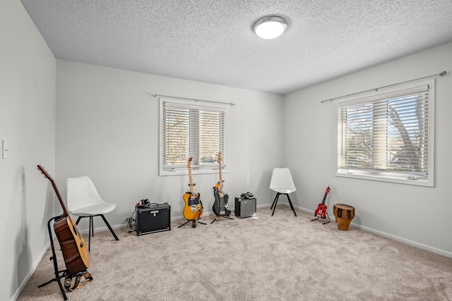 game room with baseboards, a wealth of natural light, and light colored carpet