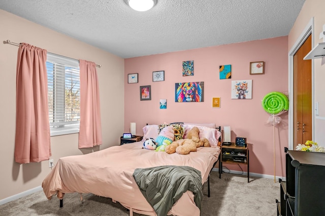 bedroom with carpet, a textured ceiling, and baseboards