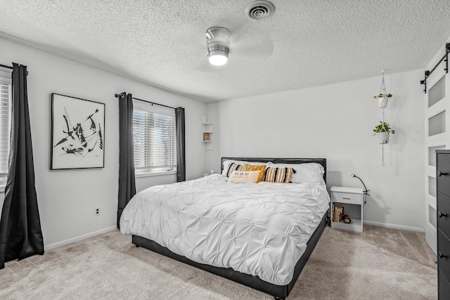 bedroom with light colored carpet, visible vents, and baseboards