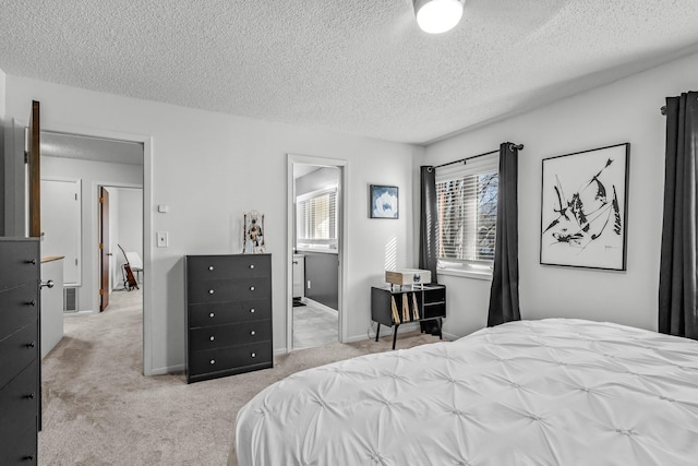 bedroom featuring baseboards, a textured ceiling, and light colored carpet