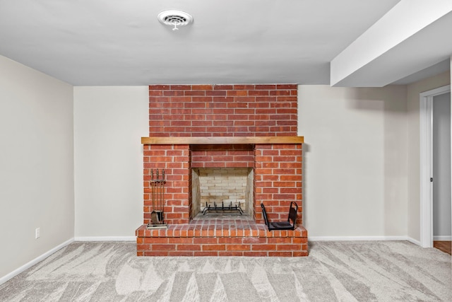 unfurnished living room with light colored carpet, visible vents, a fireplace, and baseboards