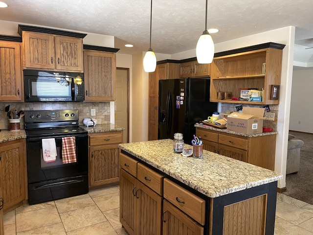 kitchen with decorative light fixtures, tasteful backsplash, brown cabinetry, a kitchen island, and black appliances