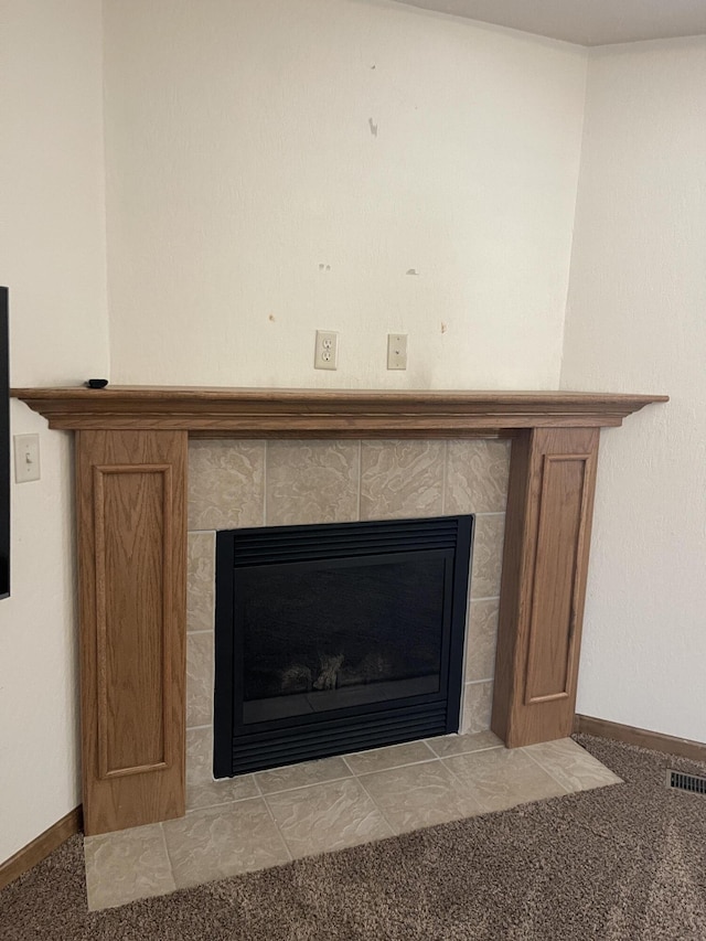 interior details with carpet, a fireplace, visible vents, and baseboards