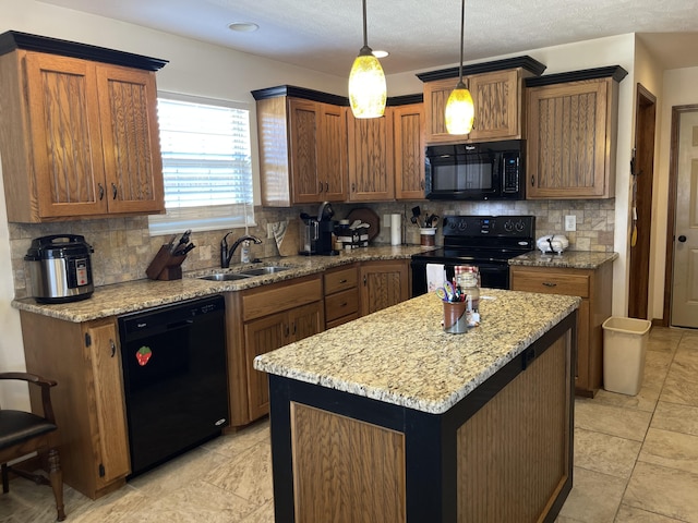 kitchen featuring a kitchen island, a sink, hanging light fixtures, brown cabinets, and black appliances