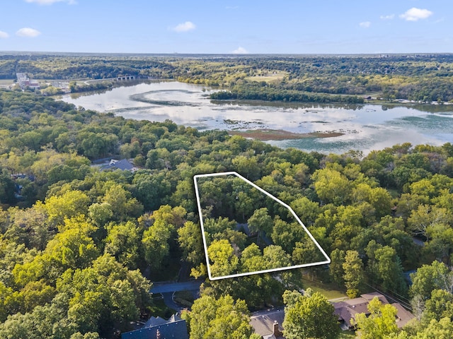 bird's eye view with a water view and a wooded view