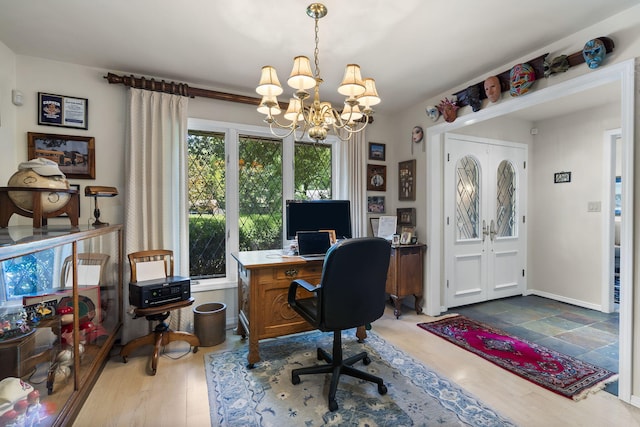 office space featuring an inviting chandelier, baseboards, and wood finished floors