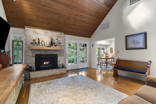 living area with light wood-type flooring, wood ceiling, visible vents, and french doors