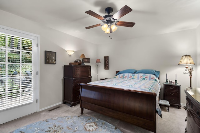 bedroom with baseboards, visible vents, ceiling fan, and light colored carpet