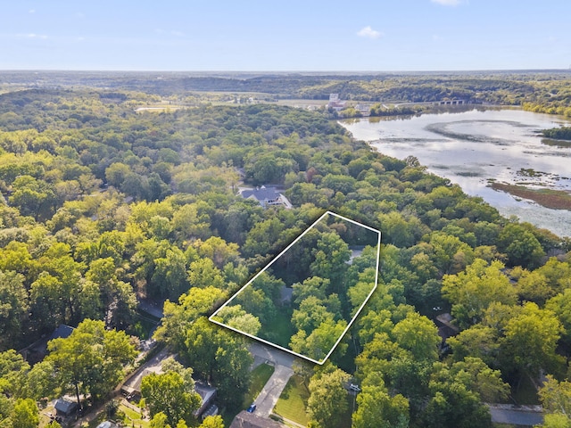 birds eye view of property with a water view and a view of trees