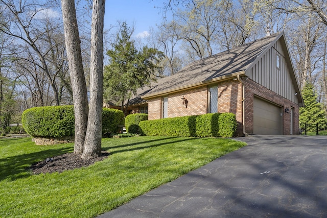view of home's exterior featuring an attached garage, a lawn, driveway, and brick siding