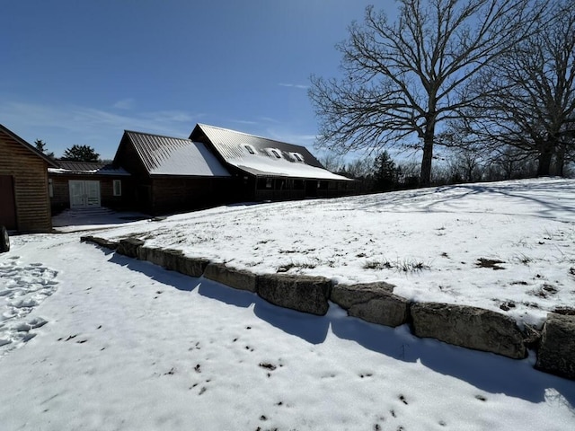 view of snowy exterior with a garage