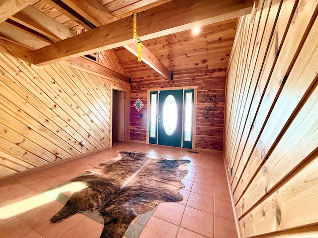 entryway featuring vaulted ceiling with beams, wood ceiling, wood walls, and light tile patterned floors