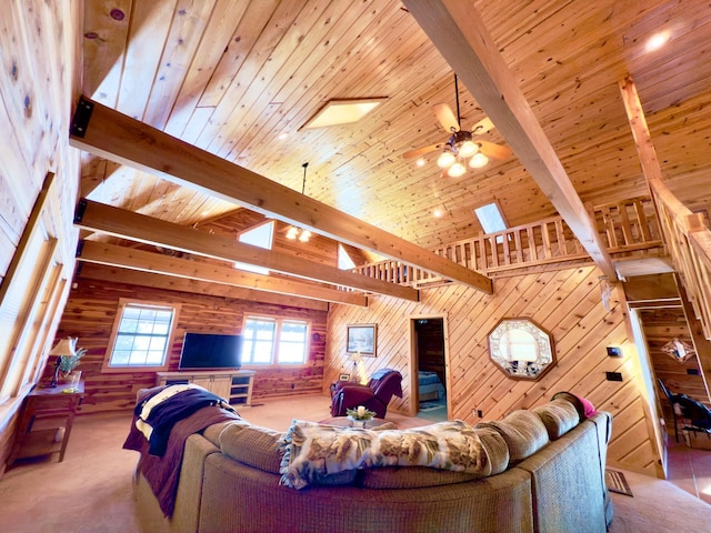 living area with carpet, wood ceiling, beamed ceiling, and wood walls