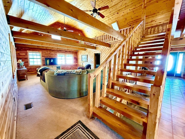 stairway featuring wooden ceiling, visible vents, a ceiling fan, and beamed ceiling