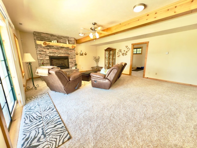 living room with light carpet, a stone fireplace, beamed ceiling, and baseboards