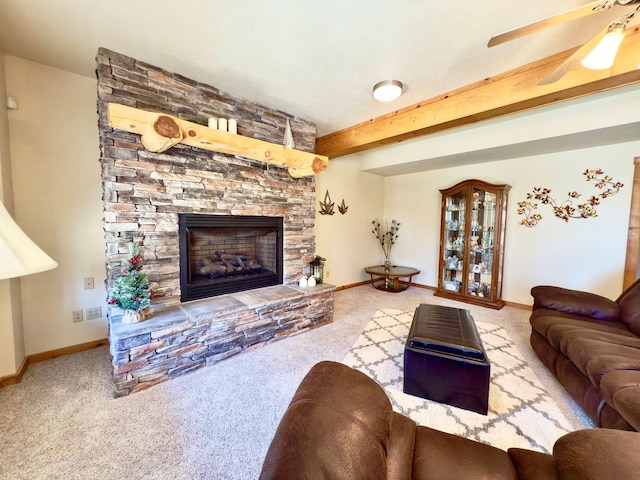 living room with baseboards, light colored carpet, a fireplace, and beamed ceiling