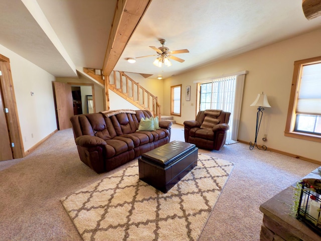 living room featuring stairs, beamed ceiling, carpet flooring, and baseboards