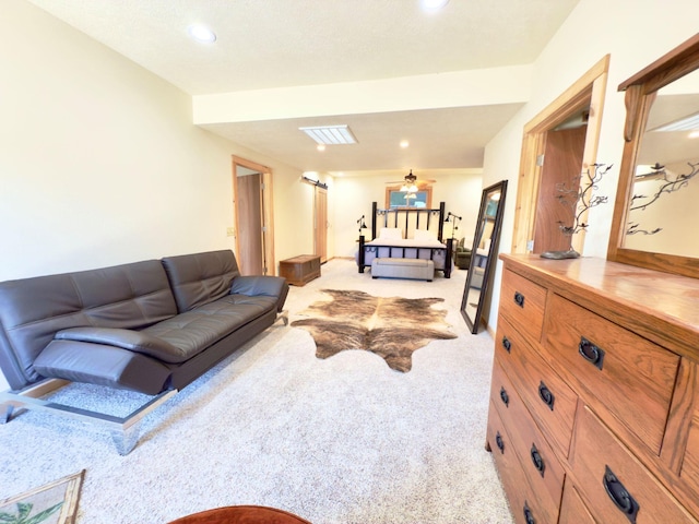 living area featuring recessed lighting, light colored carpet, and visible vents