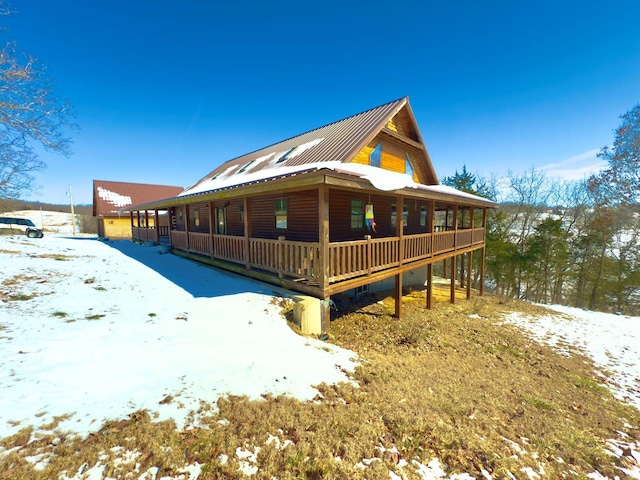 view of snow covered exterior with metal roof