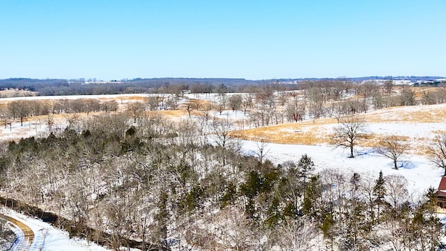 snowy aerial view featuring a rural view