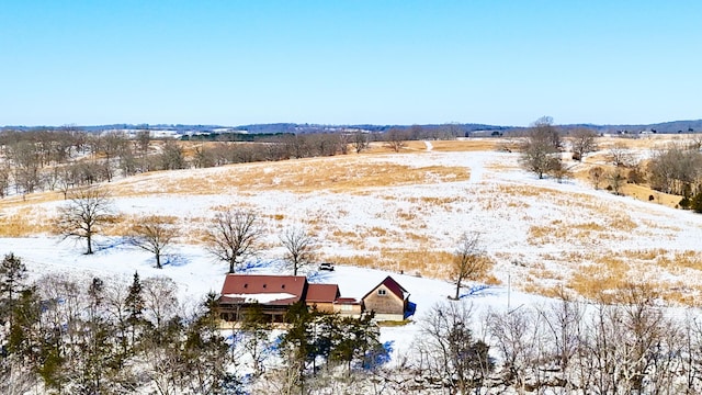 snowy aerial view featuring a rural view