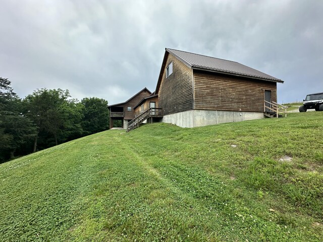 300 Roundup Ln, Bakersfield, MO 65609 - view of side of home with a yard, stairs, a wooden deck, and metal roof