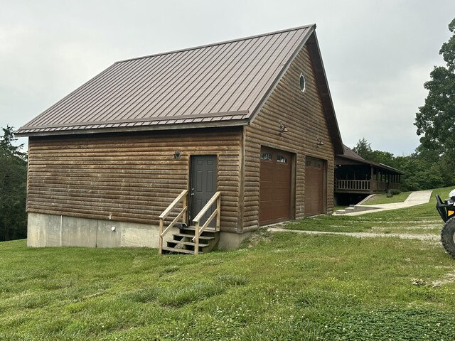 300 Roundup Ln, Bakersfield, MO 65609 - view of property exterior with entry steps, a yard, metal roof, and a garage
