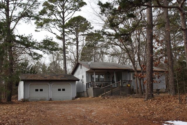 view of front facade with an outbuilding and covered porch