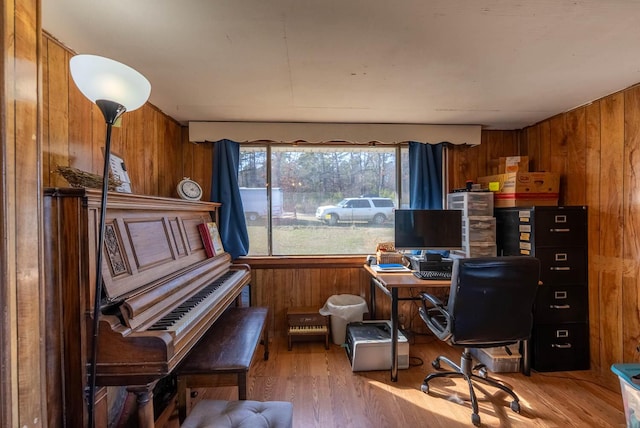 office space featuring light wood-style flooring and wooden walls