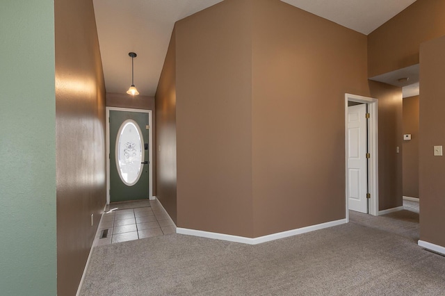 foyer featuring carpet floors, baseboards, and tile patterned floors