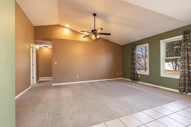 carpeted spare room featuring high vaulted ceiling, tile patterned flooring, ceiling fan, and baseboards