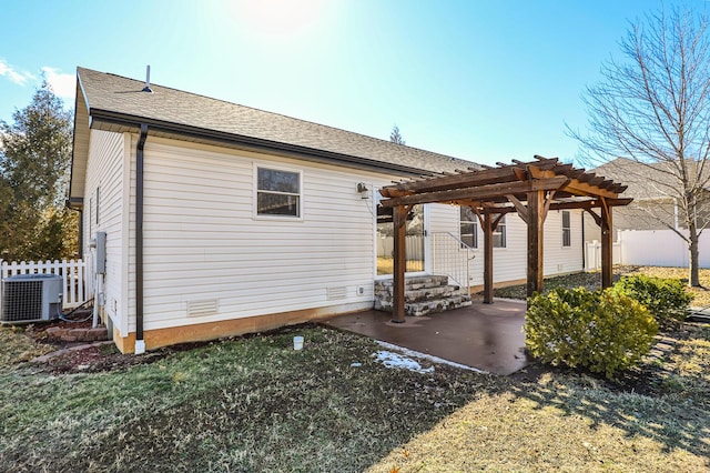 back of property featuring a patio, central AC, a shingled roof, fence, and a pergola