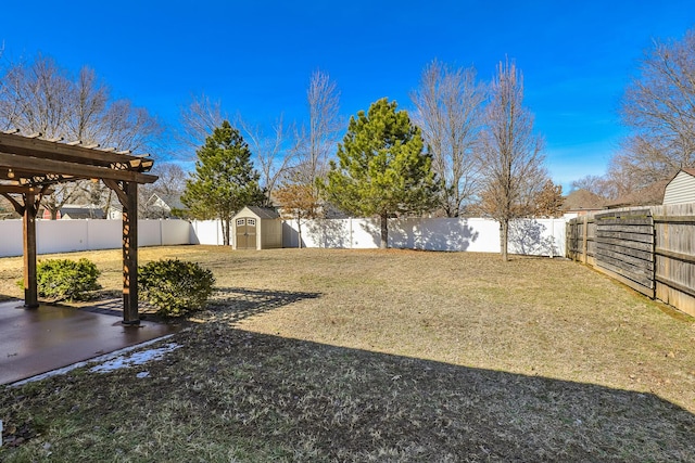 view of yard with a patio, a shed, an outdoor structure, and a fenced backyard