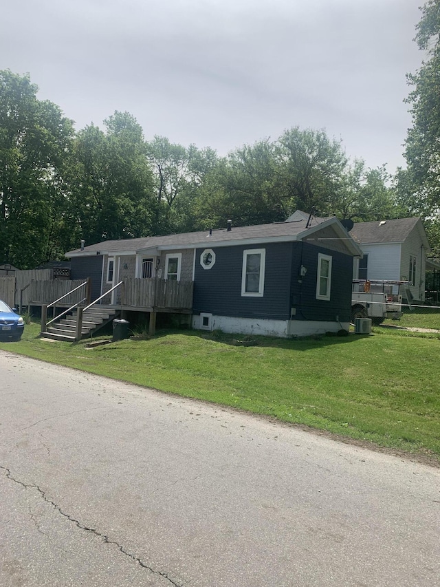 manufactured / mobile home with a front lawn and a deck