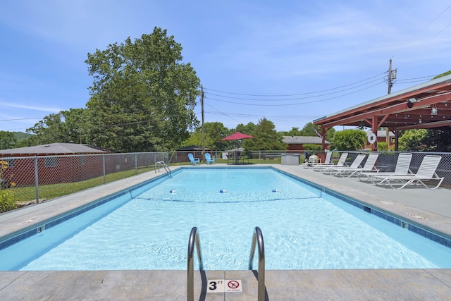 community pool featuring a patio and fence