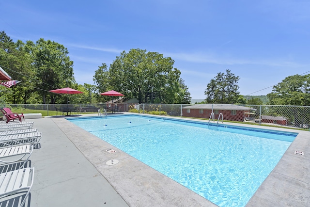 pool featuring a patio area and fence