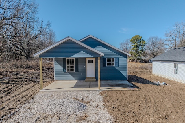 bungalow-style home with entry steps and a patio area