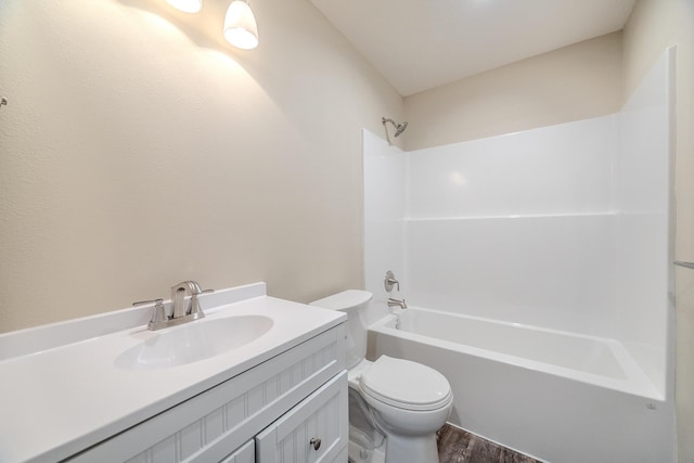 bathroom with wood finished floors, vanity, toilet, and bathing tub / shower combination