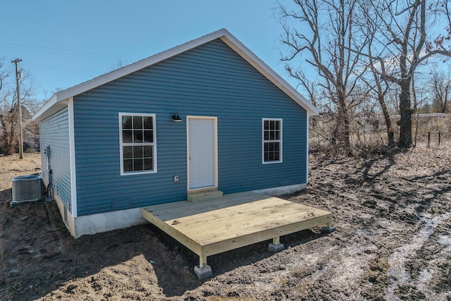 rear view of property with central air condition unit and a deck