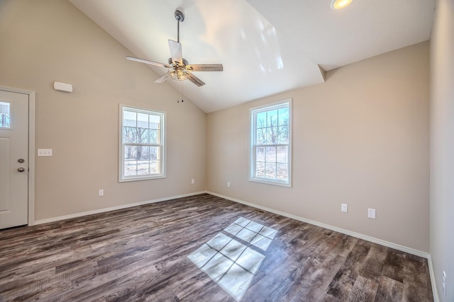 interior space featuring lofted ceiling, dark wood-style flooring, ceiling fan, and baseboards