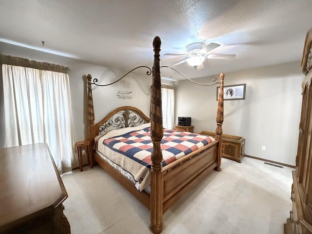 bedroom featuring light carpet, multiple windows, visible vents, and baseboards