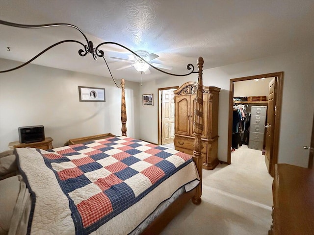 bedroom featuring a closet, light carpet, and a spacious closet