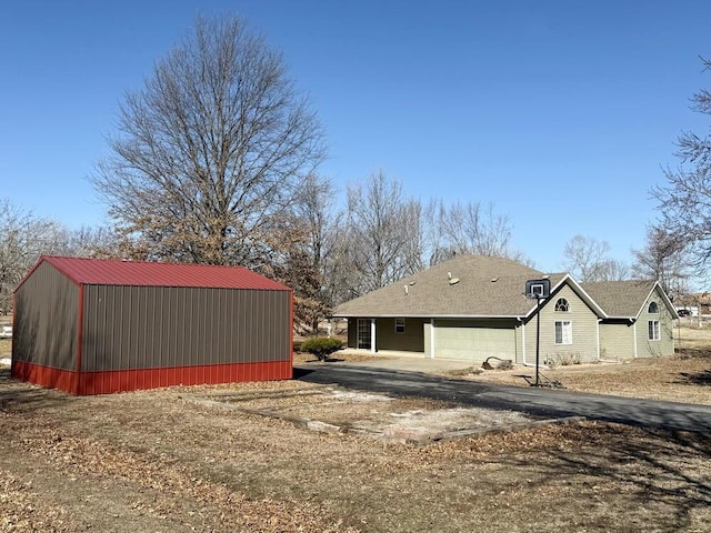 view of side of property with dirt driveway