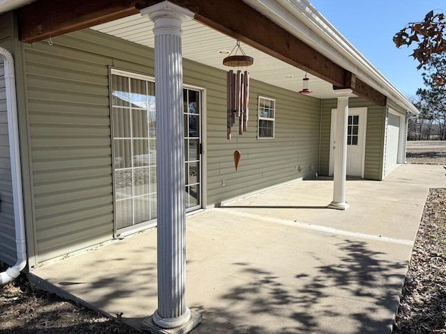 view of patio with driveway and an attached garage