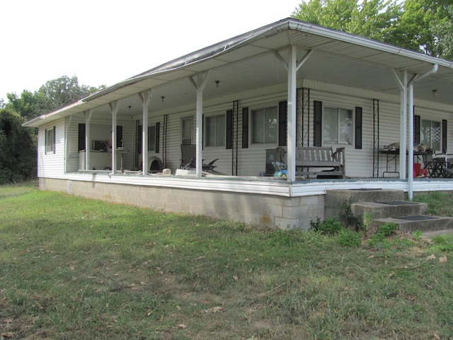 back of property featuring a porch and a yard