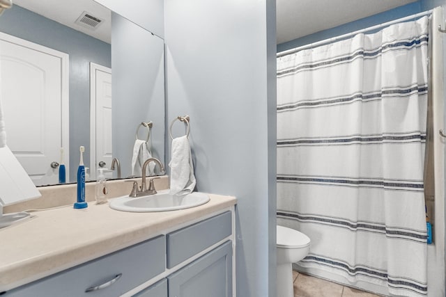 187 Clubhouse Dr Unit 19, Branson, MO 65616 - bathroom featuring visible vents, a shower with shower curtain, toilet, vanity, and tile patterned flooring