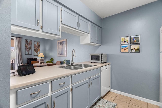 187 Clubhouse Dr Unit 19, Branson, MO 65616 - kitchen featuring light tile patterned floors, white dishwasher, a sink, baseboards, and light countertops