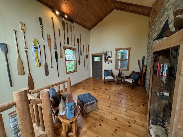 sitting room with high vaulted ceiling, light wood-type flooring, and wood ceiling