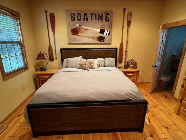 bedroom featuring light wood-type flooring and baseboards