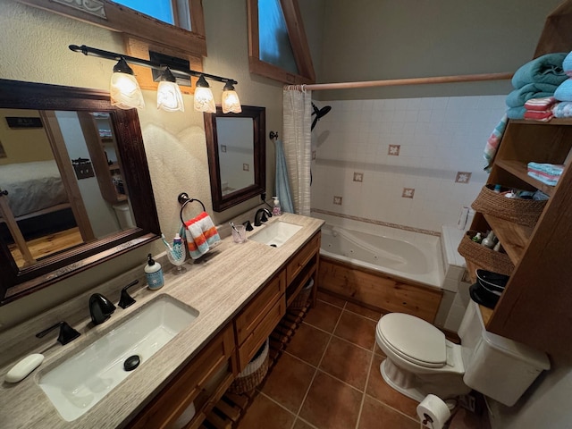 ensuite bathroom featuring a whirlpool tub, double vanity, a sink, and tile patterned floors